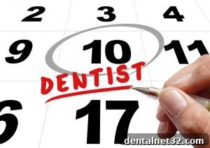 A friendly dentist in Holly Springs explaining the importance of using annual dental insurance benefits before they expire.