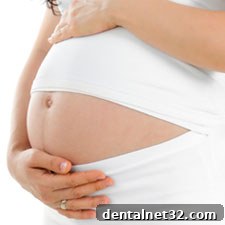 A smiling pregnant woman holding her belly, illustrating the importance of health during pregnancy.