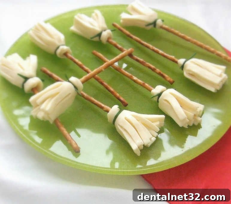 Healthy Halloween treat made of cheese and pretzel sticks to look like a witch's broom.
