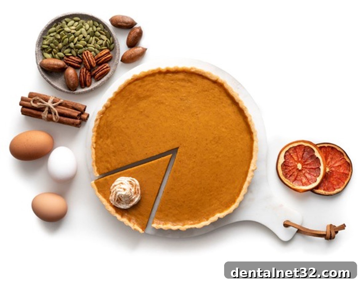 A slice of pumpkin pie next to a fork