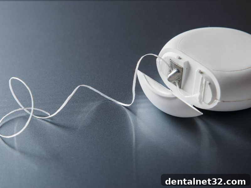 Close-up of dental floss and a toothbrush, representing the daily dental care routine.