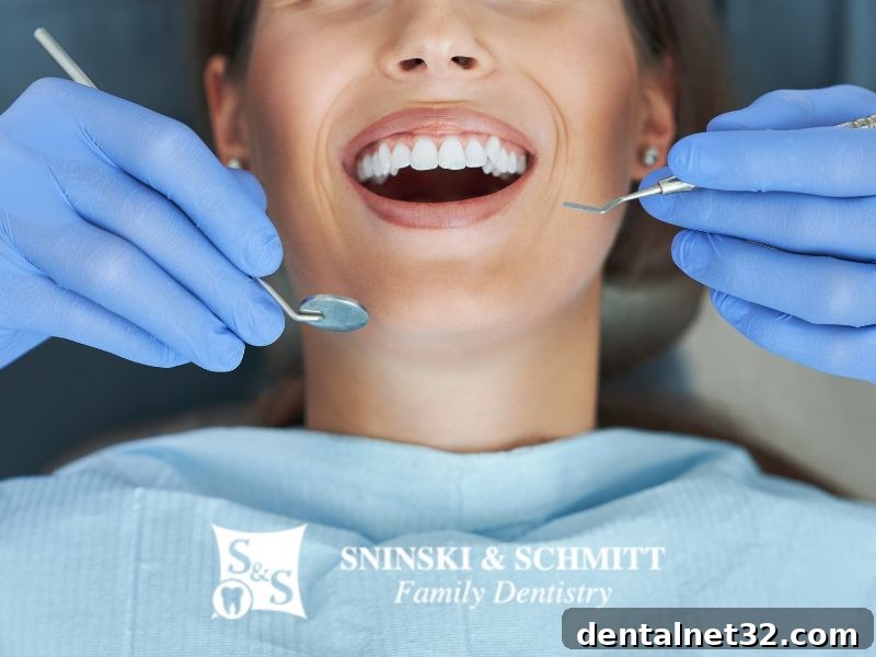 A smiling woman with healthy teeth, symbolizing the connection between oral hygiene and overall health.