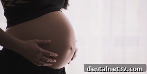 a pregnant woman smiling and holding her belly